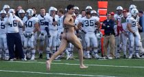 A streaker, with MIT (Massachusetts Institute of Technology) written on his back, makes his way down the field interrupting the Yale-Harvard college football game during the fourth quarter, Saturday, Nov. 18, 2006 in Boston.