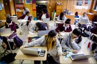 Jackie Cornejo, 16, left, and Elisa Martinez, 16, work on a problem in a math class at the Young Women's College Preparatory Academy in Houston. The school is one of the first in the Houston district to give laptops to students for use at school and at home.